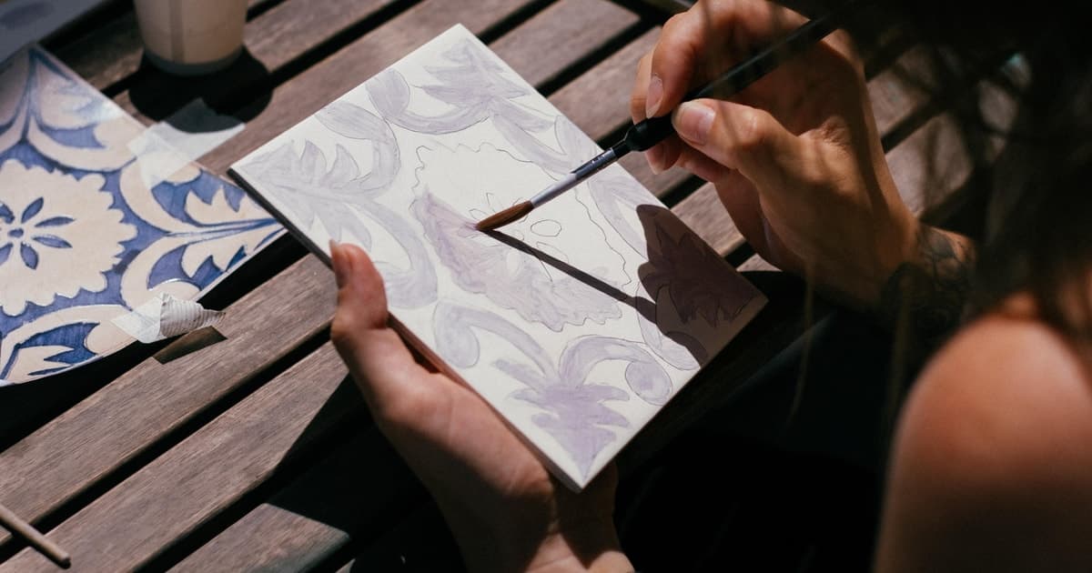 Painting Porto azulejo tile at ceramic studio with artist