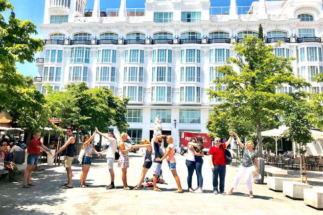 Travelers writing the word 'Madrid' with their bodies during a guruwalk in the Spanish capital. 